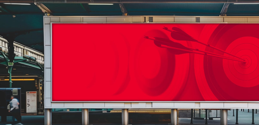 A red billboard with a opaque bullseye target and 3 arrows in the center