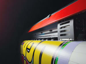 A long shot of a production printer producing a high quality vinyl graphic