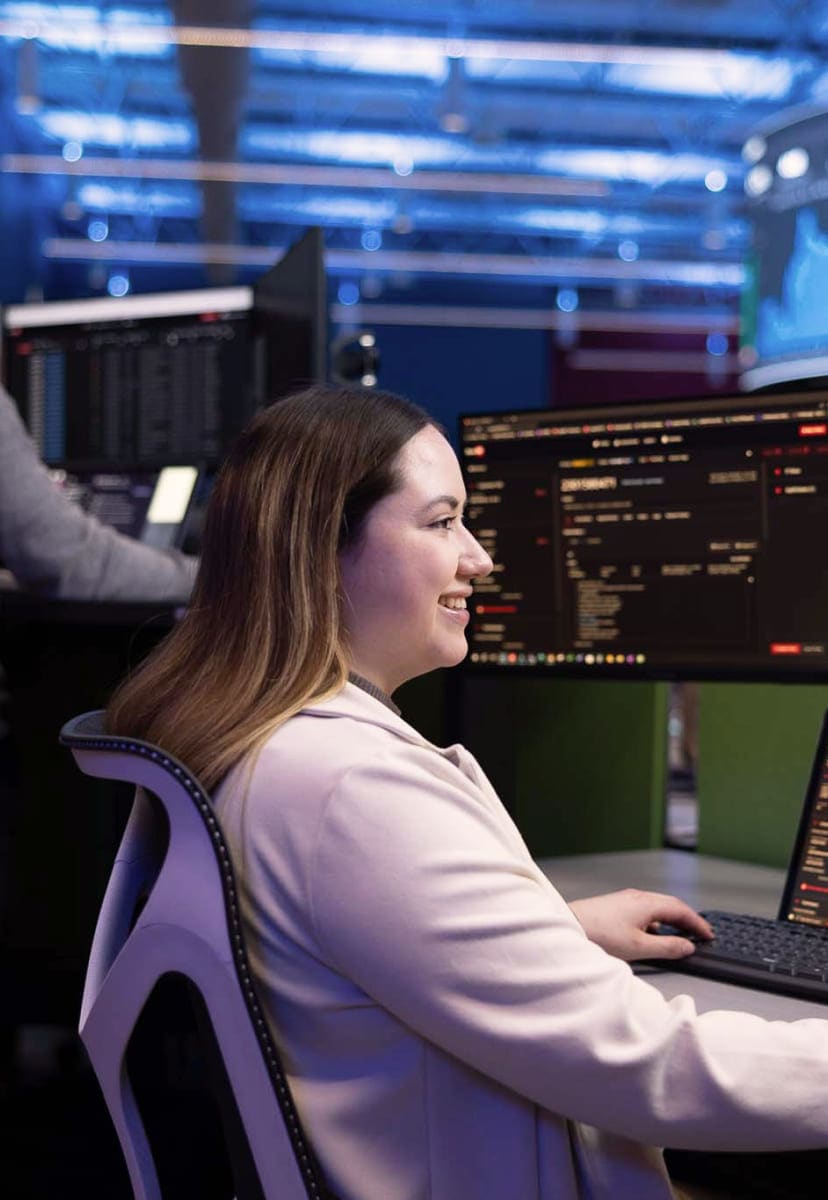 woman working at computer desk smiling