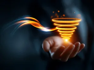 A person holding out their palm, an orange swirling cone of light floats above their hand
