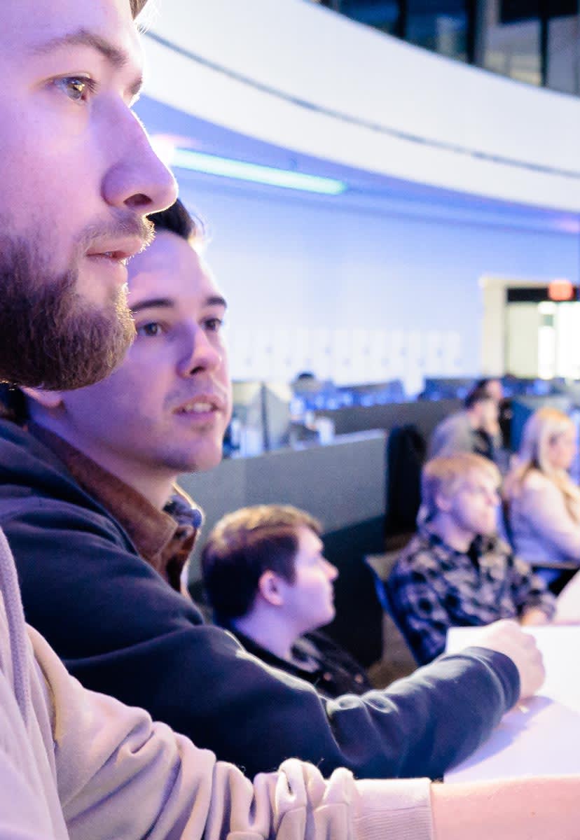 two men working at computer desk 