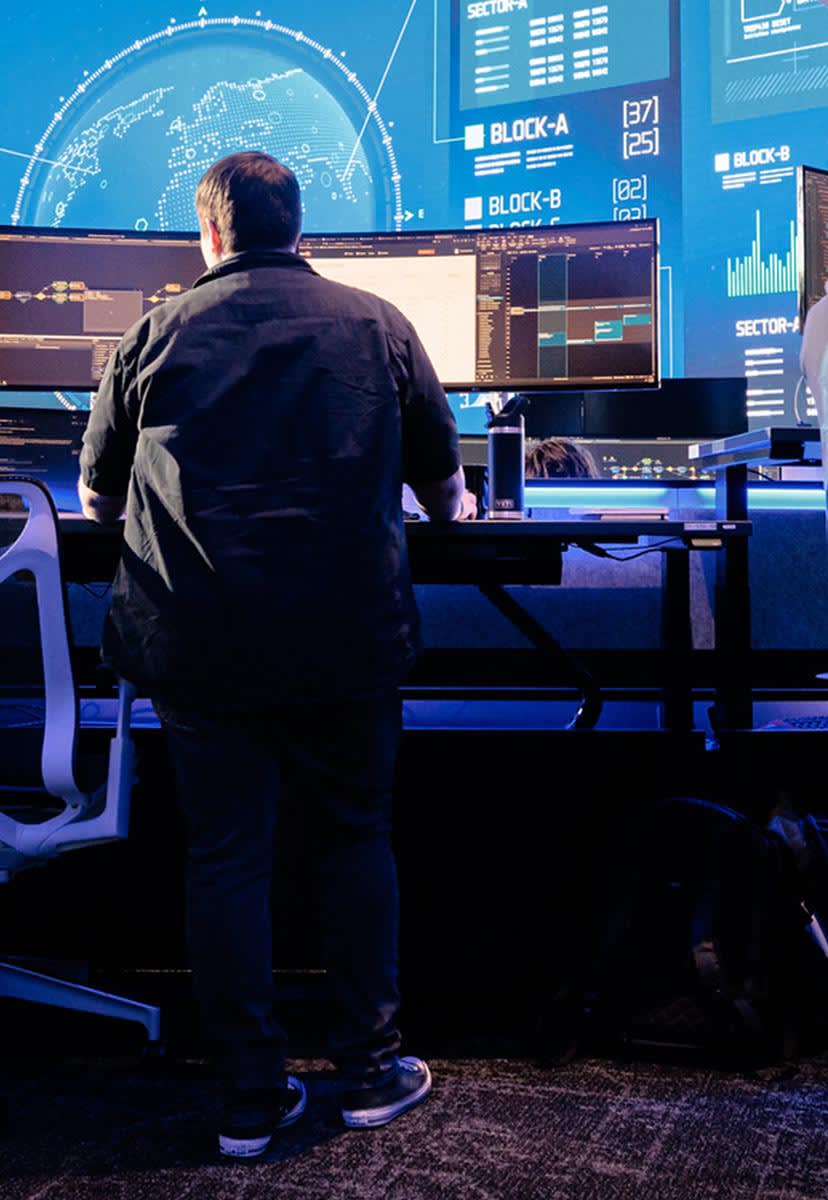 woman working at desk in high tech office with blue lights