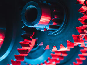 Red and steel cogs spinning together 