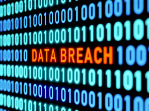 A screen of binary numbers with the words 'data breach' in the middle colored orange