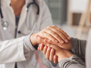 Doctor holding a patient's hands