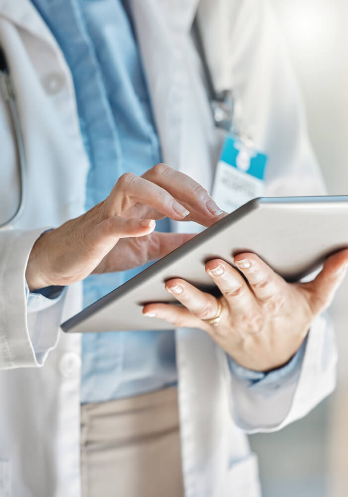 A doctor working on a tablet