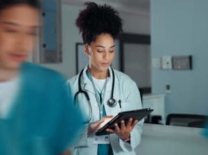 A medical professional using a smart tablet