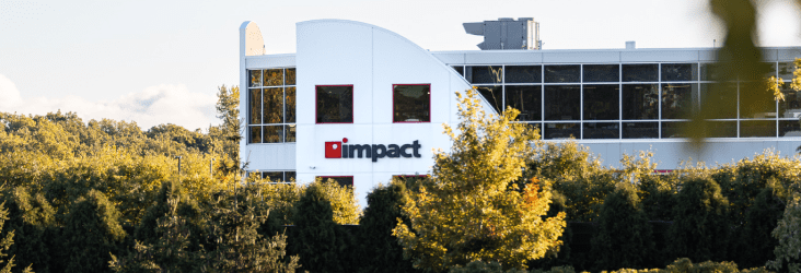 Sun-kissed trees framing the Impact Networking HQ building in Lake Forest