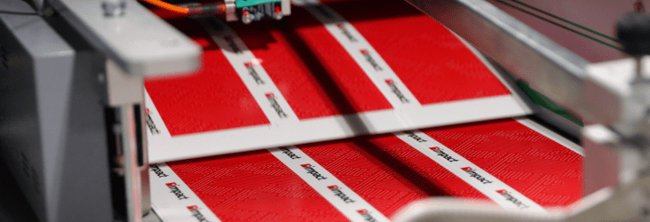 A enterprise caliber printer completing an Impact branded job.