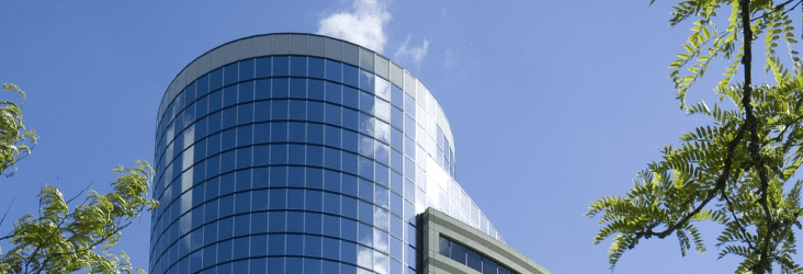 A large building with a glass turret - ground level perspective.