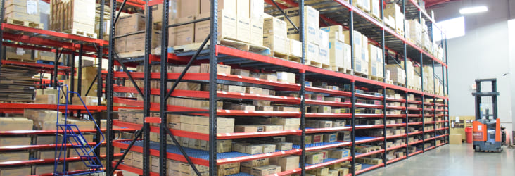 Warehouse wracks stocked with boxes in various sizes.