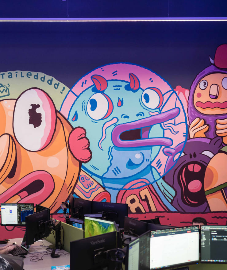 three unique cartoon characters in large colorful mural
