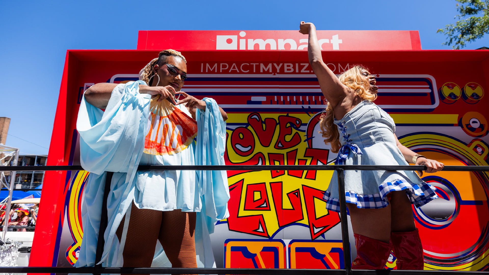 Two Impact employees on the company's float at the Chicago Pride Parade