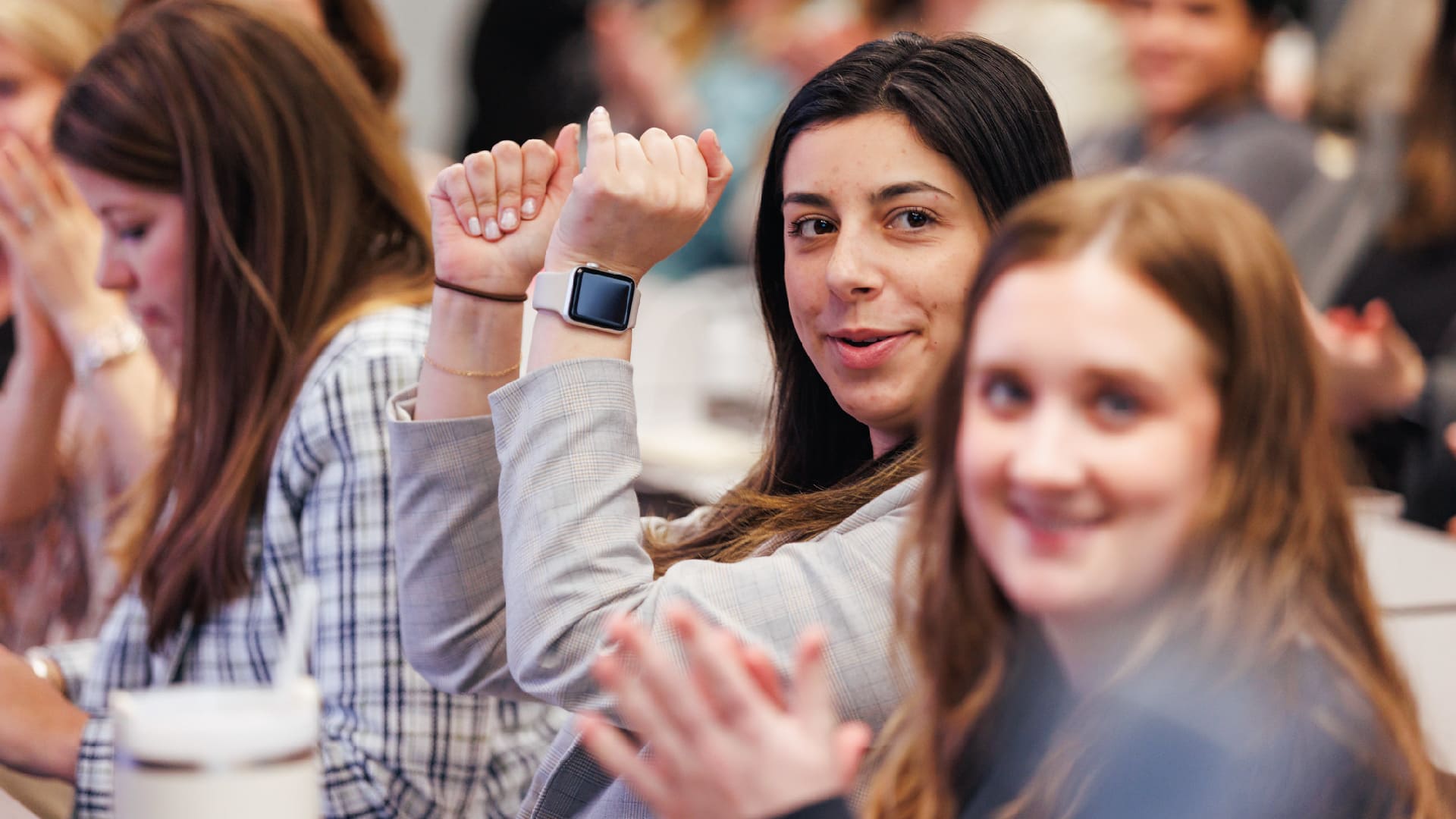 Cheering women at Impact in a classroom