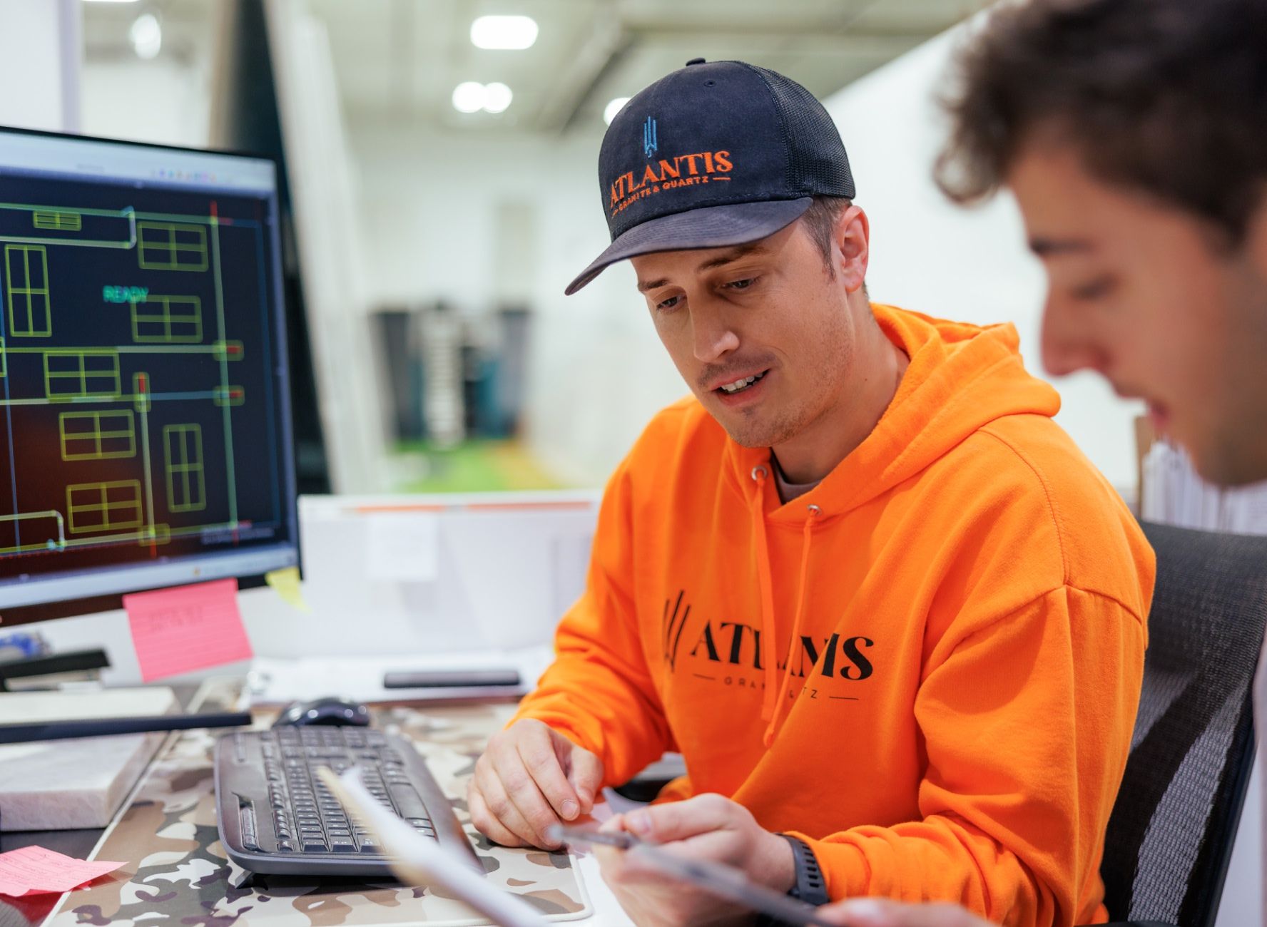 Fabrication Engineer wearing Atlantis swag with measurements on screen