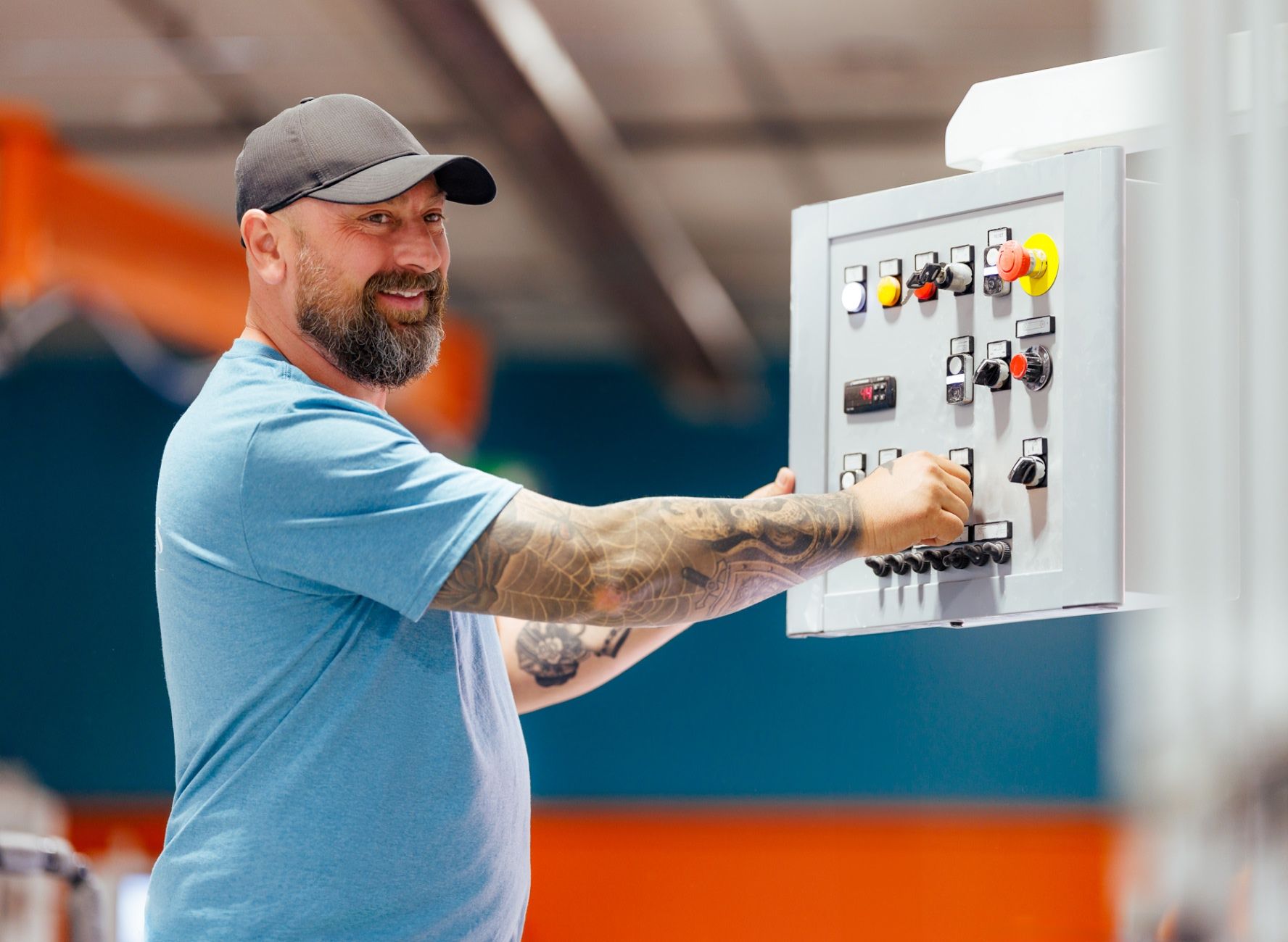 Atlantis Fabrication Shop Operator using control panel to use machinery