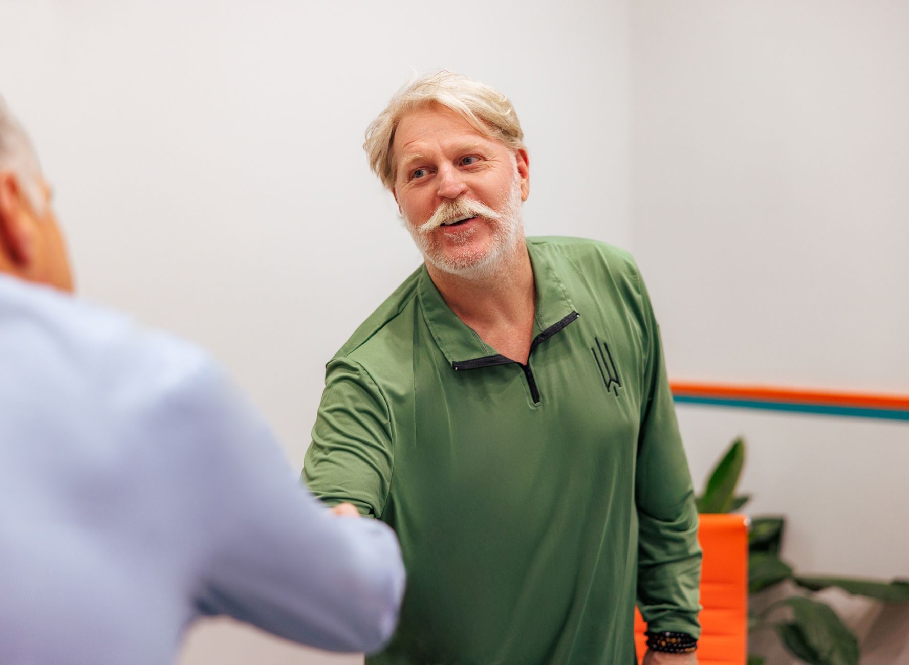 PJ Ryan shaking hands with prospective client in Atlantis Granite and Quartz conference room