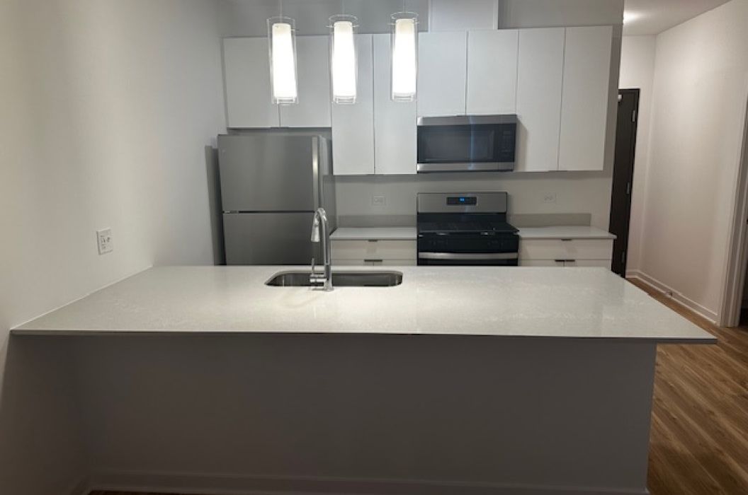 Corner apartment kitchen White Quartz island at 157+Cicero Apartments