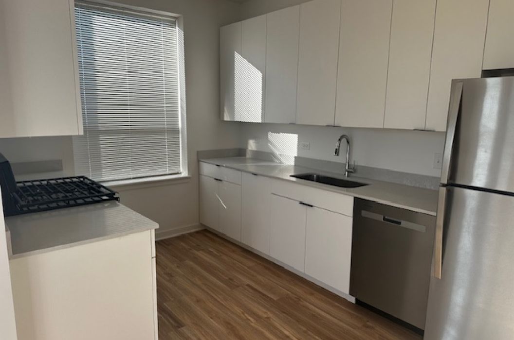 Apartment kitchen with grey quartz countertops at 157+Cicero Apartments in Oak Forest, IL.