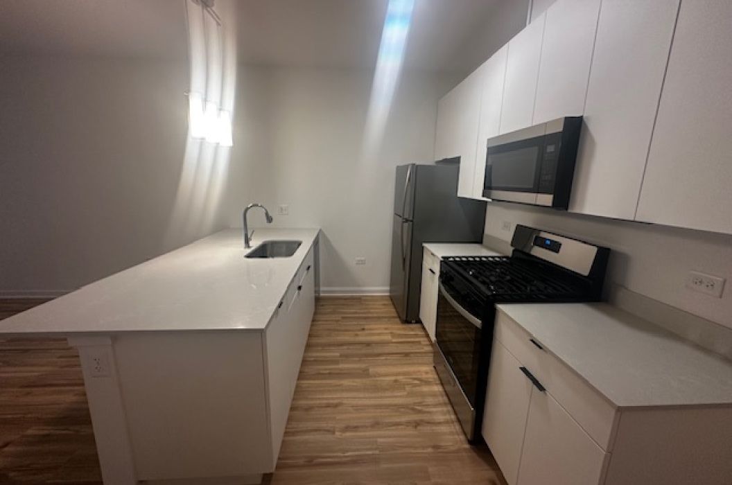 Apartment kitchen with quartz island at 157+Cicero Apartments in Oak Forest, IL.
