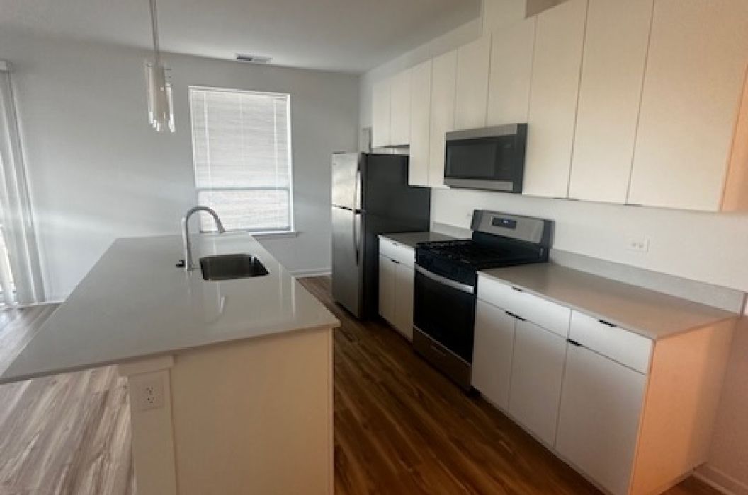 Apartment kitchen with quartz island at 157+Cicero Apartments in Oak Forest, IL.