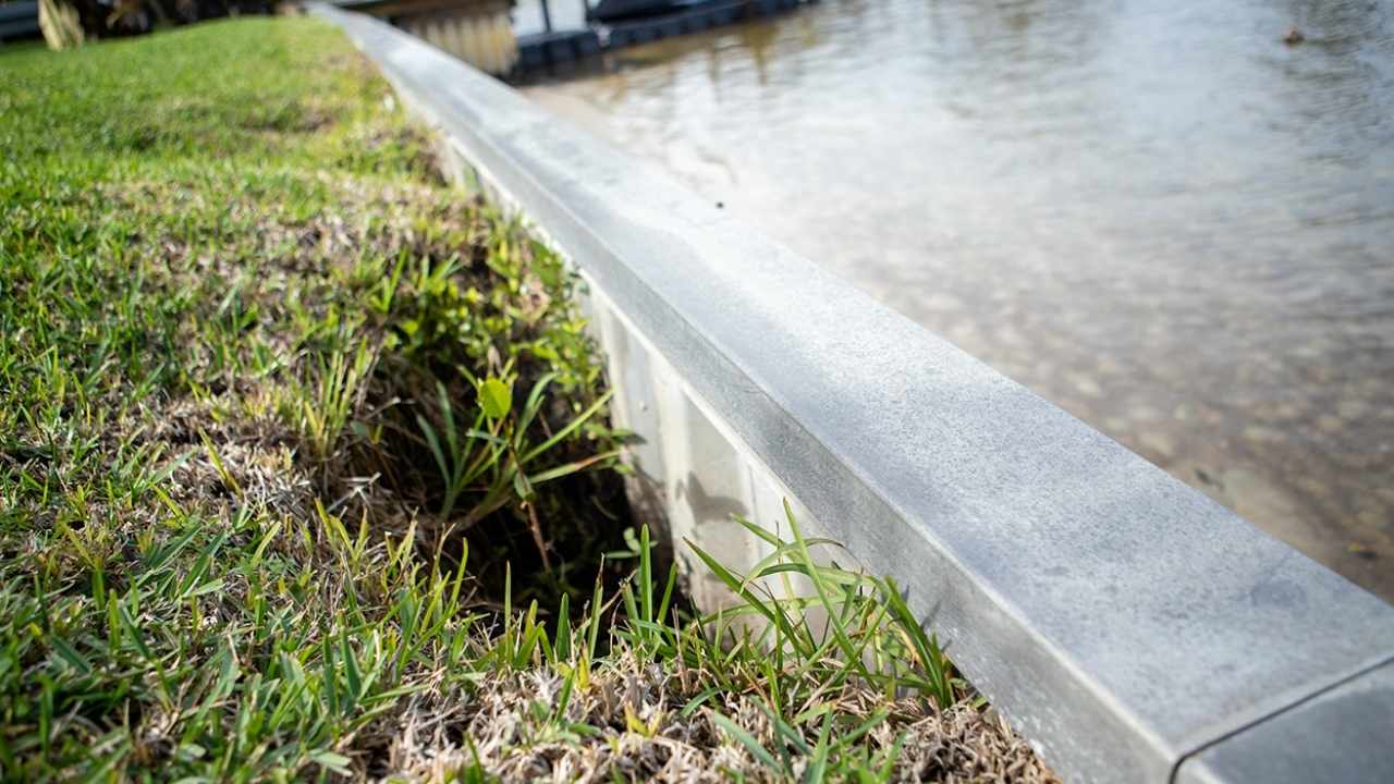 image of a seawall with soil loss that is in need of polyurethane injection seawall repair